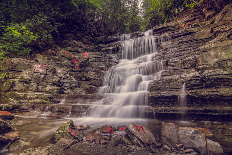 A waterfall down a series of rocks shaped like a stairway